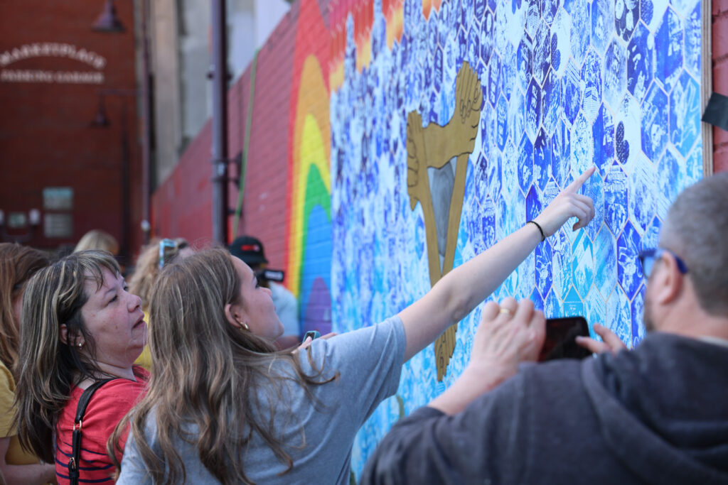 people admiring the BHS BCL mural