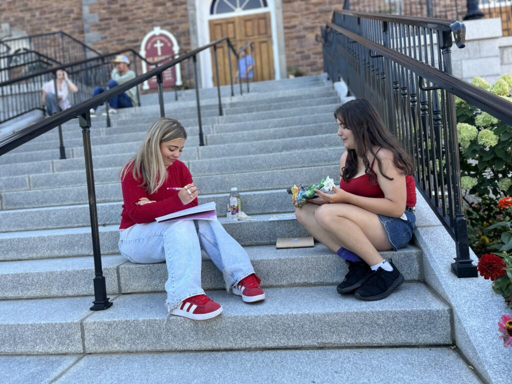 students sitting on Church steps