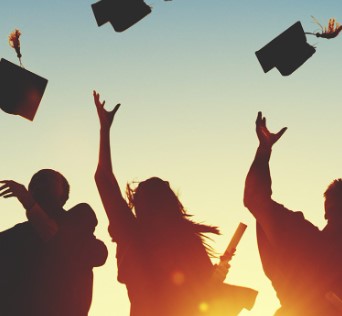 2026.06.16 silhouette image of people at dusk tossing their caps and holding diplomas 2026.06.16 silhouette image of people at dusk tossing their caps and holding diplomas